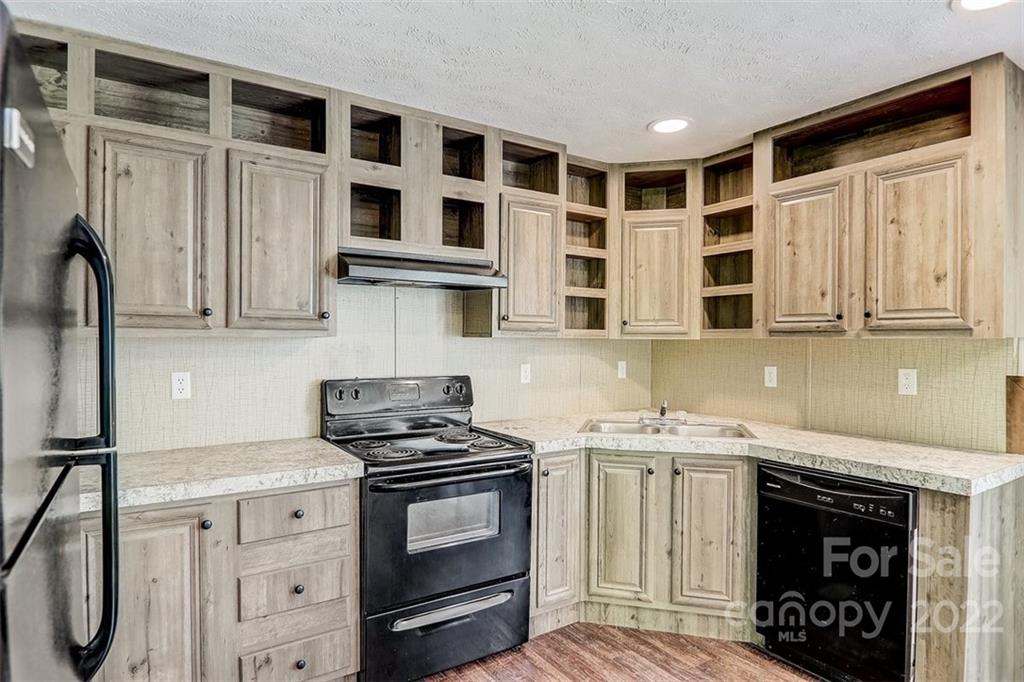 78 Alexander Road Alexander, NC 28701 - Photo 7 of 21 a kitchen with stainless steel appliances granite countertop a stove and a sink
