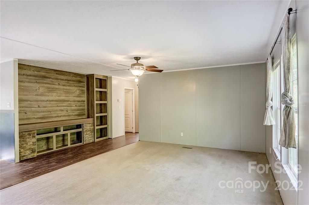 78 Alexander Road Alexander, NC 28701 - Photo 8 of 21 a view of an empty room with a fireplace and a window