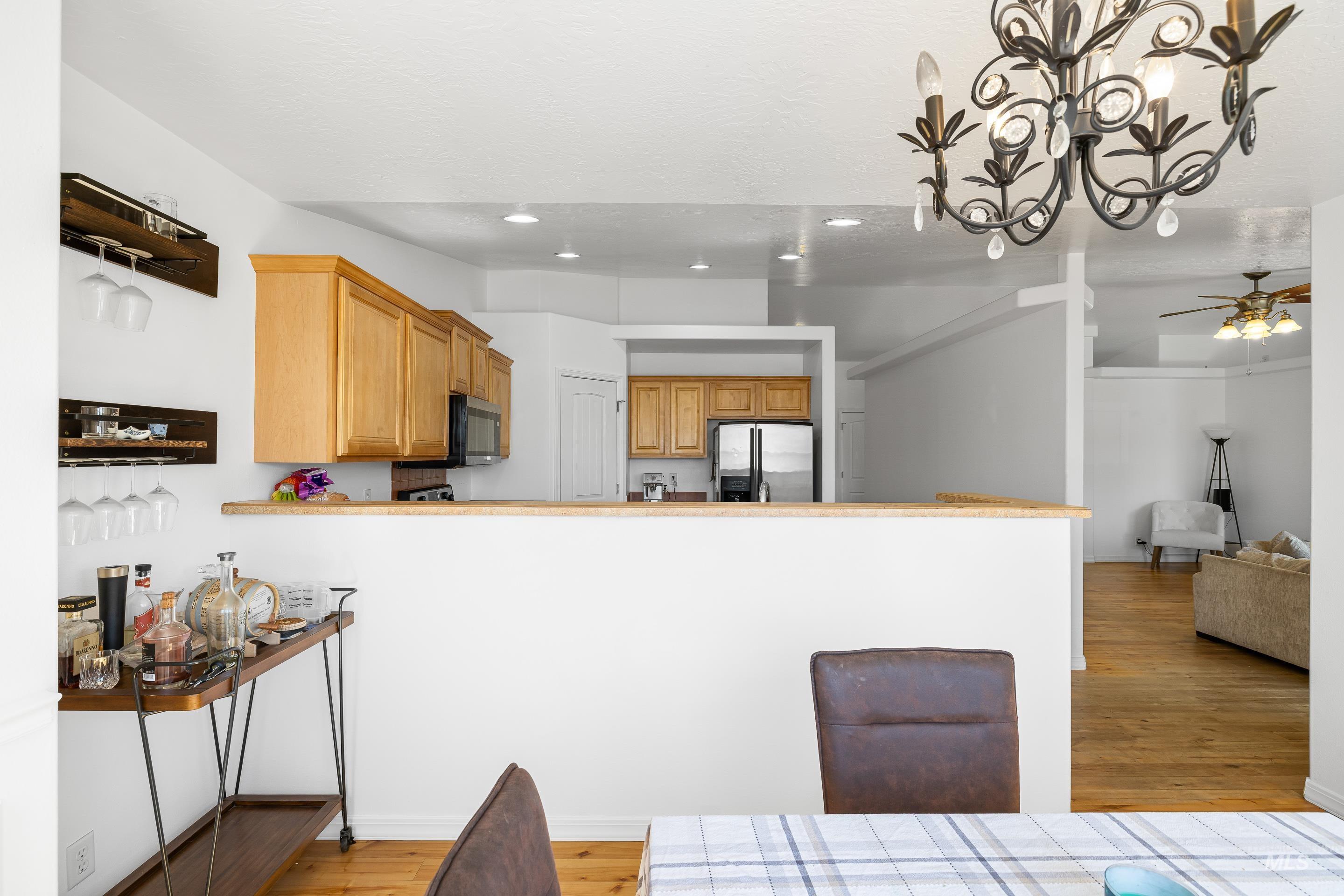 215 Northeast Rosa Court Mountain Home, ID 83647 - Photo 19 of 39 Kitchen with light wood finished floors, stainless steel appliances, a peninsula, light countertops, and recessed lighting