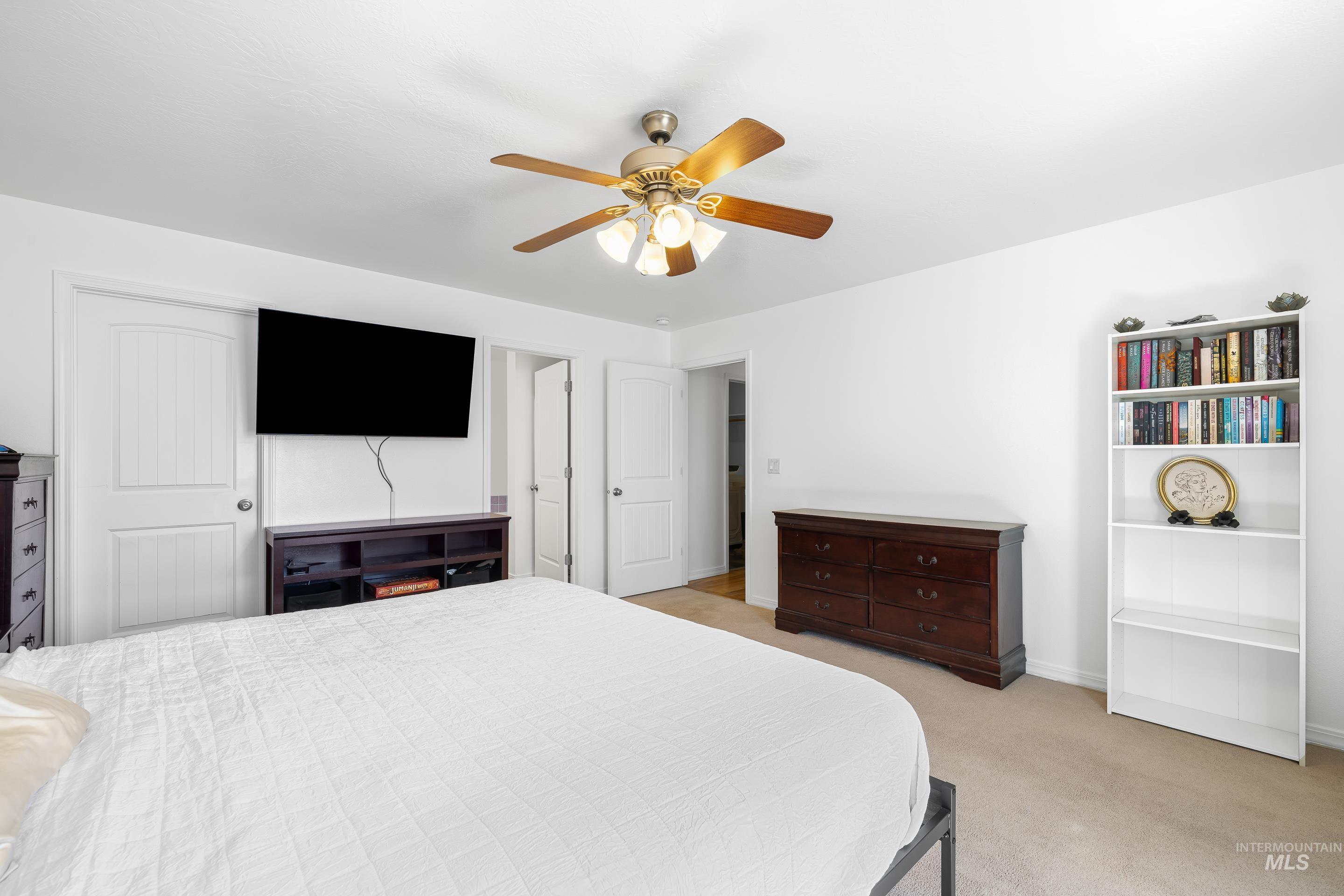 215 Northeast Rosa Court Mountain Home, ID 83647 - Photo 23 of 39 Bedroom with a ceiling fan and light carpet