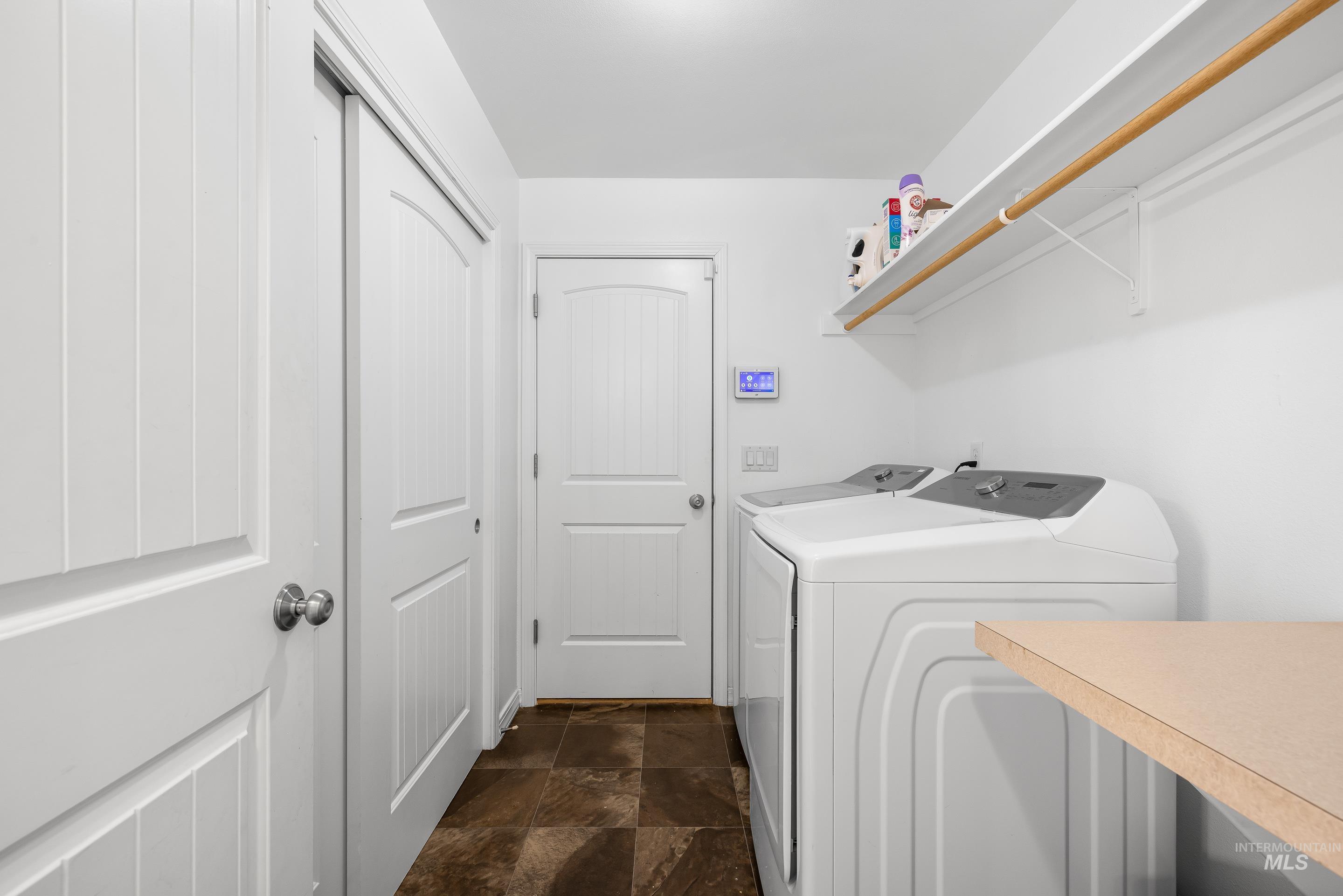 215 Northeast Rosa Court Mountain Home, ID 83647 - Photo 34 of 39 Laundry area with stone finish flooring and washer and dryer