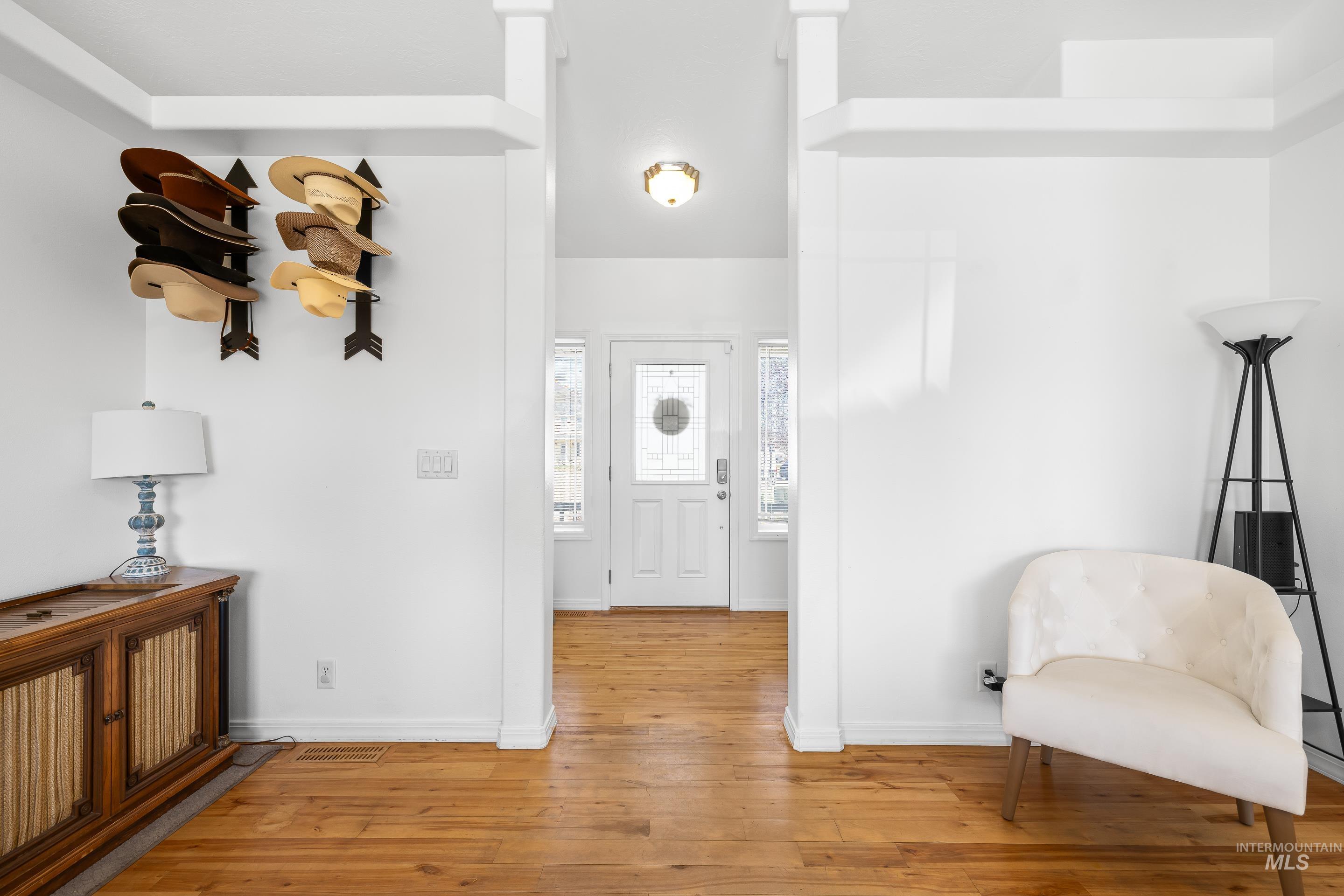 215 Northeast Rosa Court Mountain Home, ID 83647 - Photo 6 of 39 Foyer with light wood-style flooring and baseboards