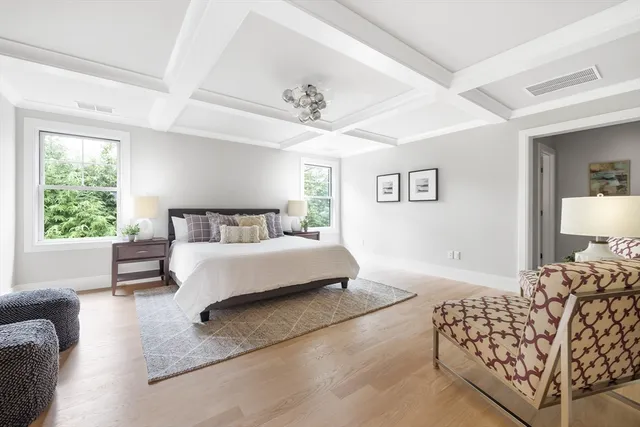 a bedroom with a bed couch and window