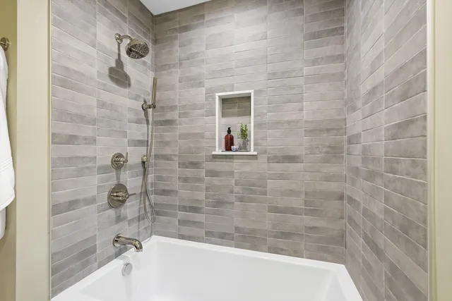 a bathroom with a bathtub and shower