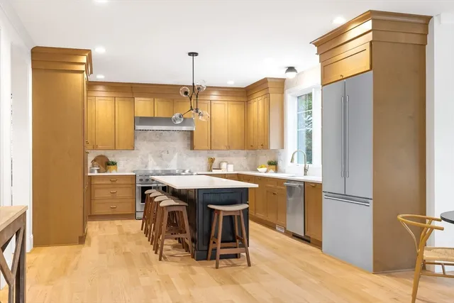 a kitchen with a sink appliances and cabinets