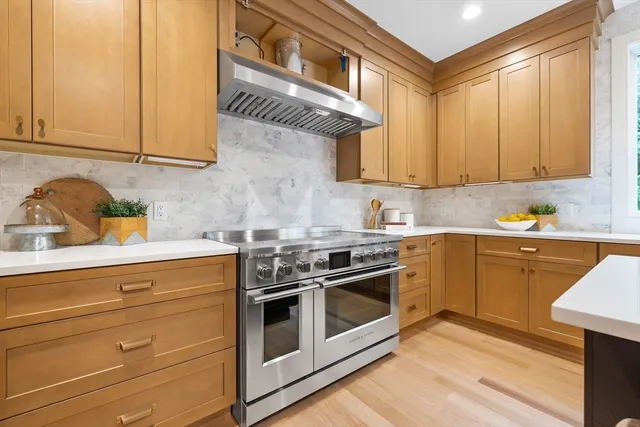 a kitchen with granite countertop a stove and a sink