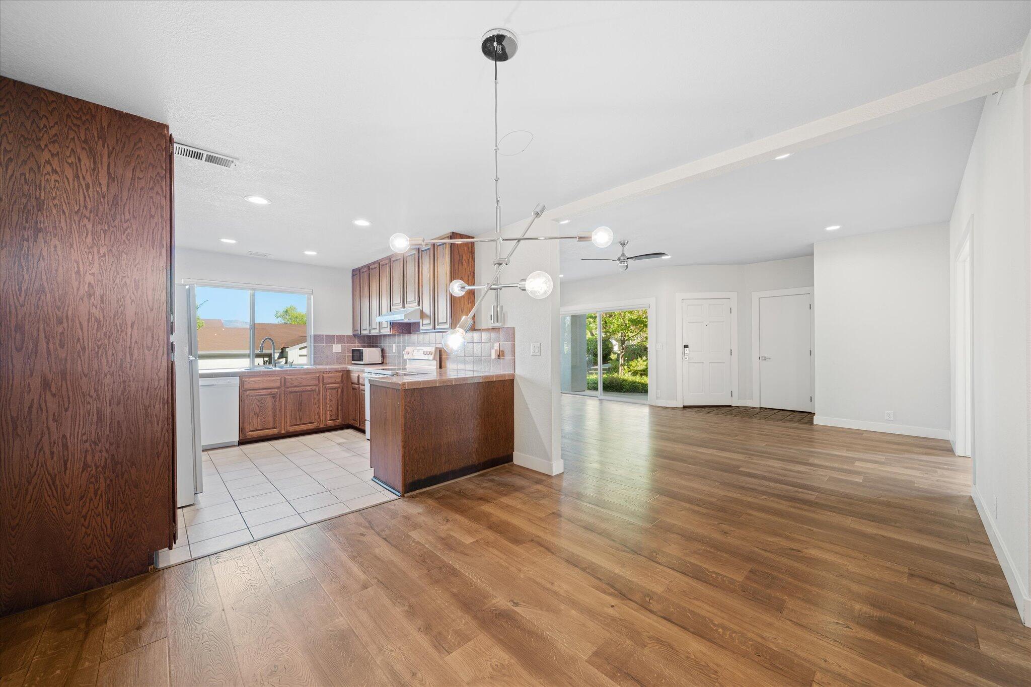 488 Ridgecrest Trail, Unit 132 Redding, CA 96003 - Photo 14 of 51 a view of a kitchen with kitchen island a sink wooden floor and living room view