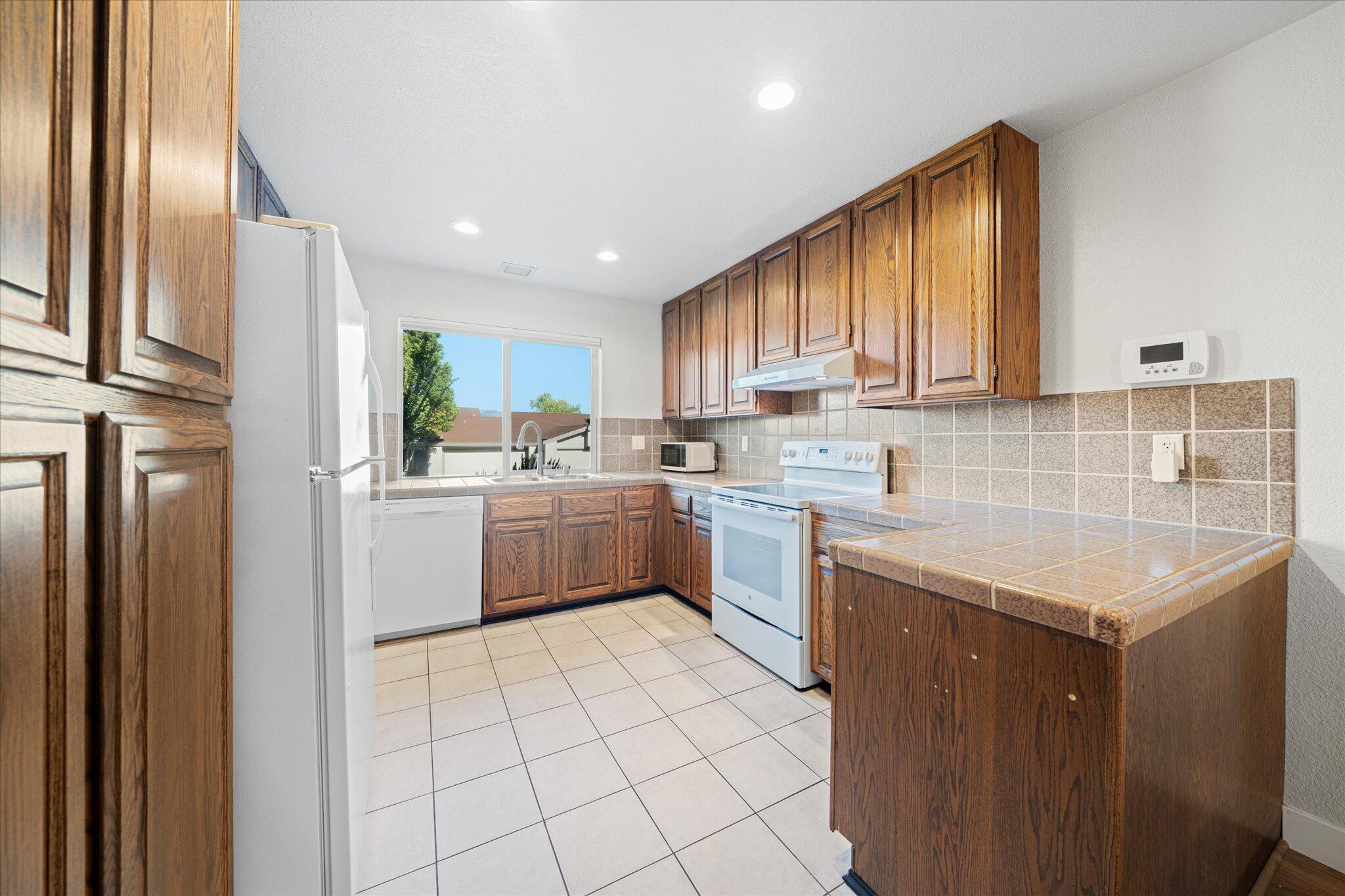 488 Ridgecrest Trail, Unit 132 Redding, CA 96003 - Photo 15 of 51 a kitchen with a sink a stove cabinets and a window