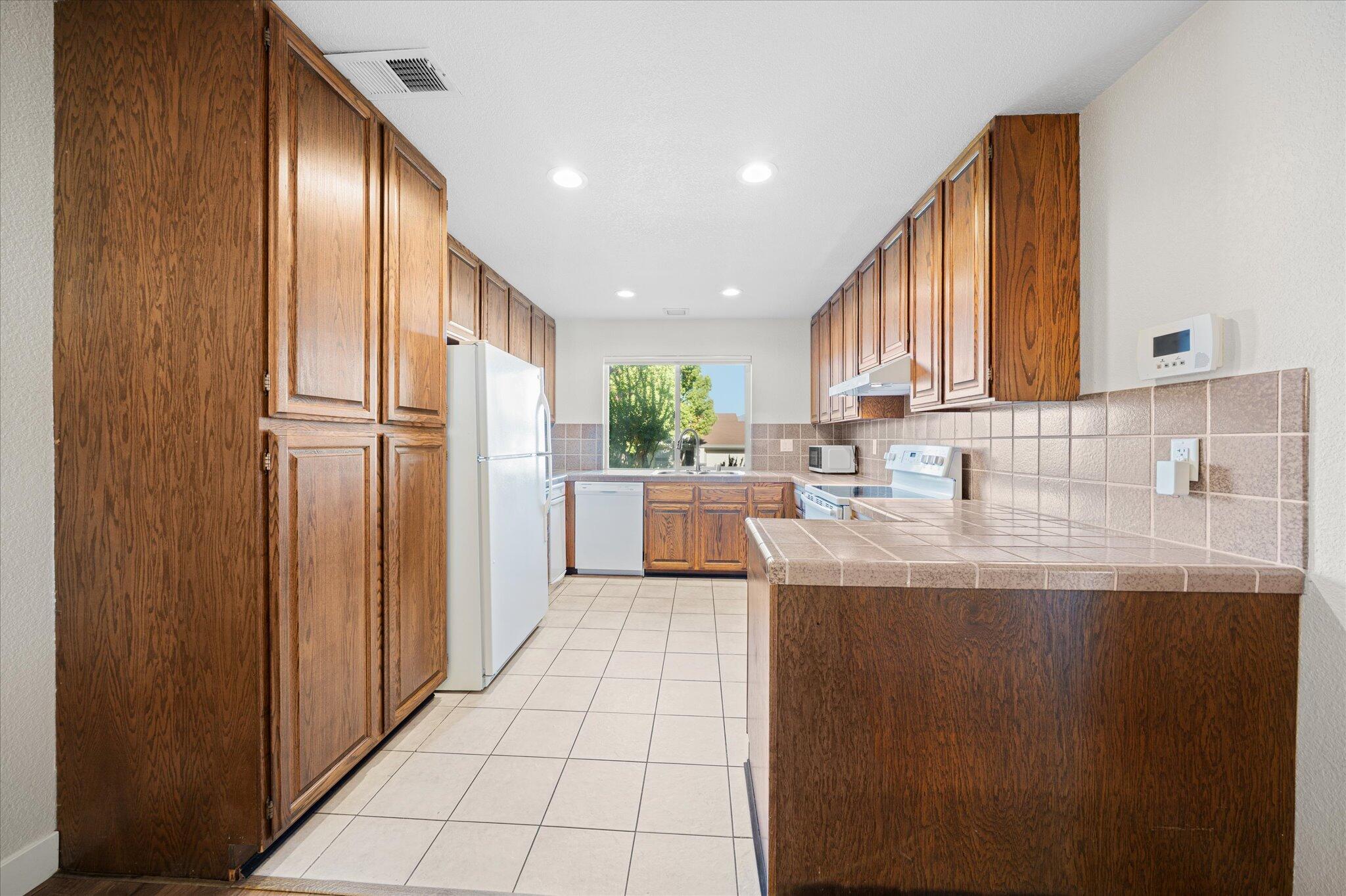 488 Ridgecrest Trail, Unit 132 Redding, CA 96003 - Photo 16 of 51 a kitchen with stainless steel appliances granite countertop a refrigerator a sink and a stove