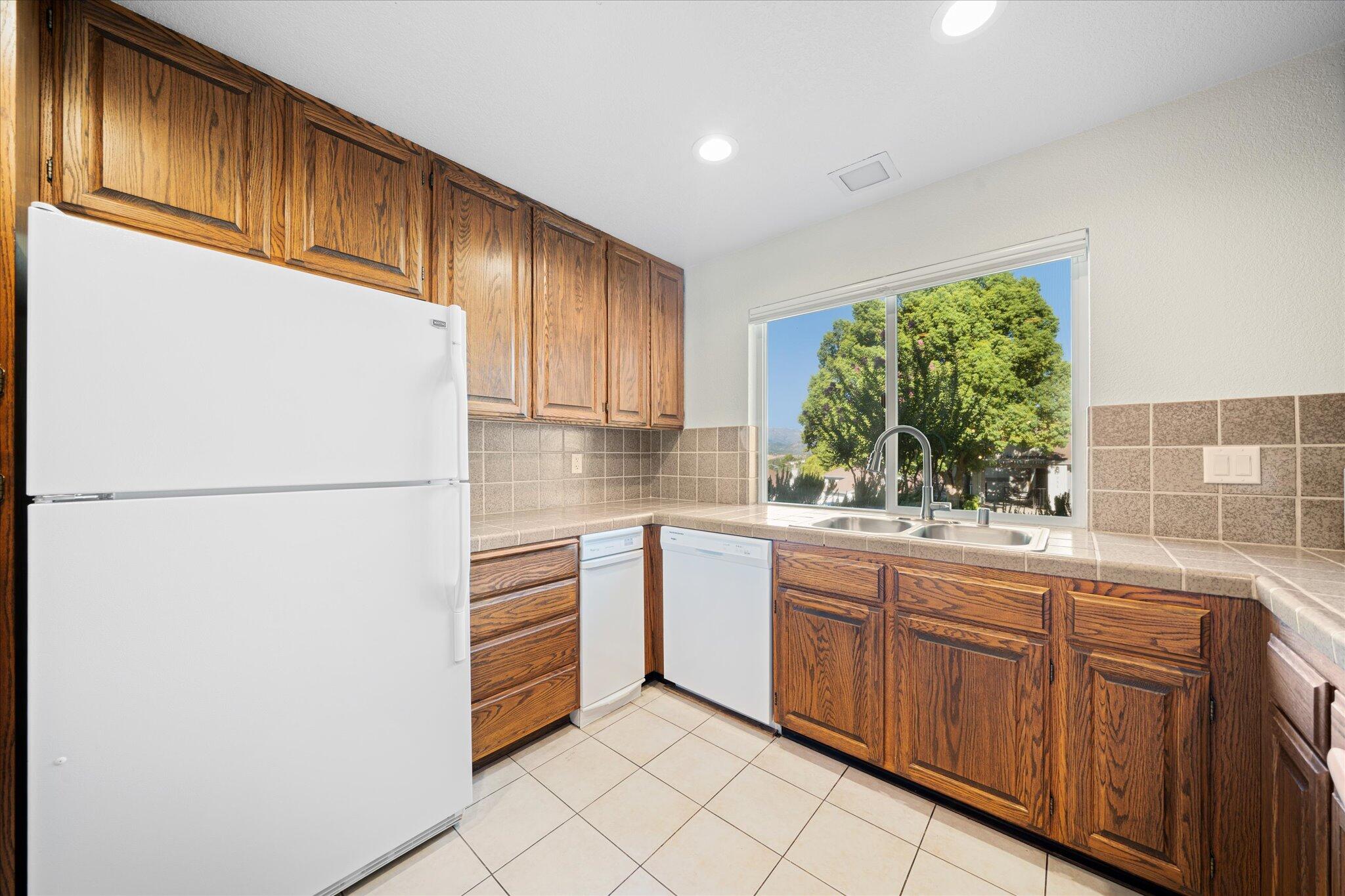 488 Ridgecrest Trail, Unit 132 Redding, CA 96003 - Photo 17 of 51 a kitchen with a refrigerator sink and cabinets