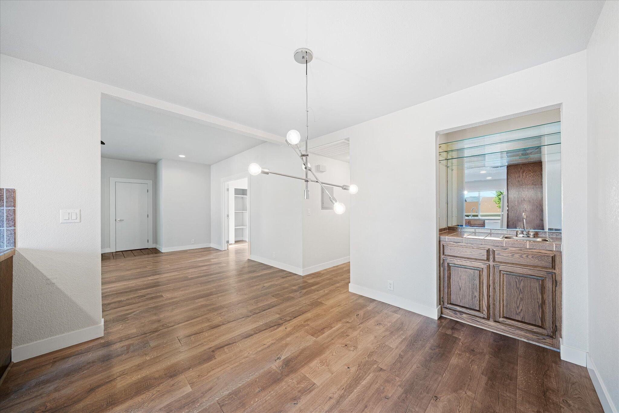 488 Ridgecrest Trail, Unit 132 Redding, CA 96003 - Photo 21 of 51 a view of a kitchen with a sink dishwasher a refrigerator and wooden floor