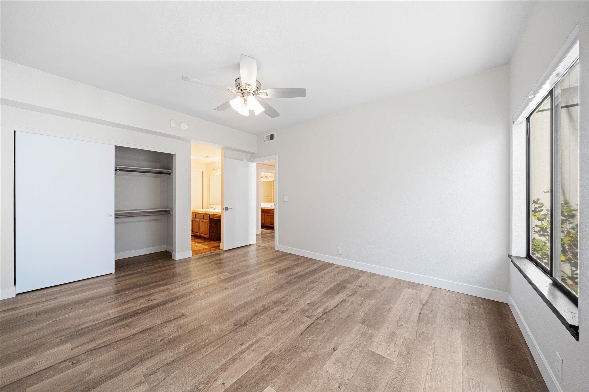 488 Ridgecrest Trail, Unit 132 Redding, CA 96003 - Photo 23 of 51 an empty room with wooden floor chandelier fan and windows