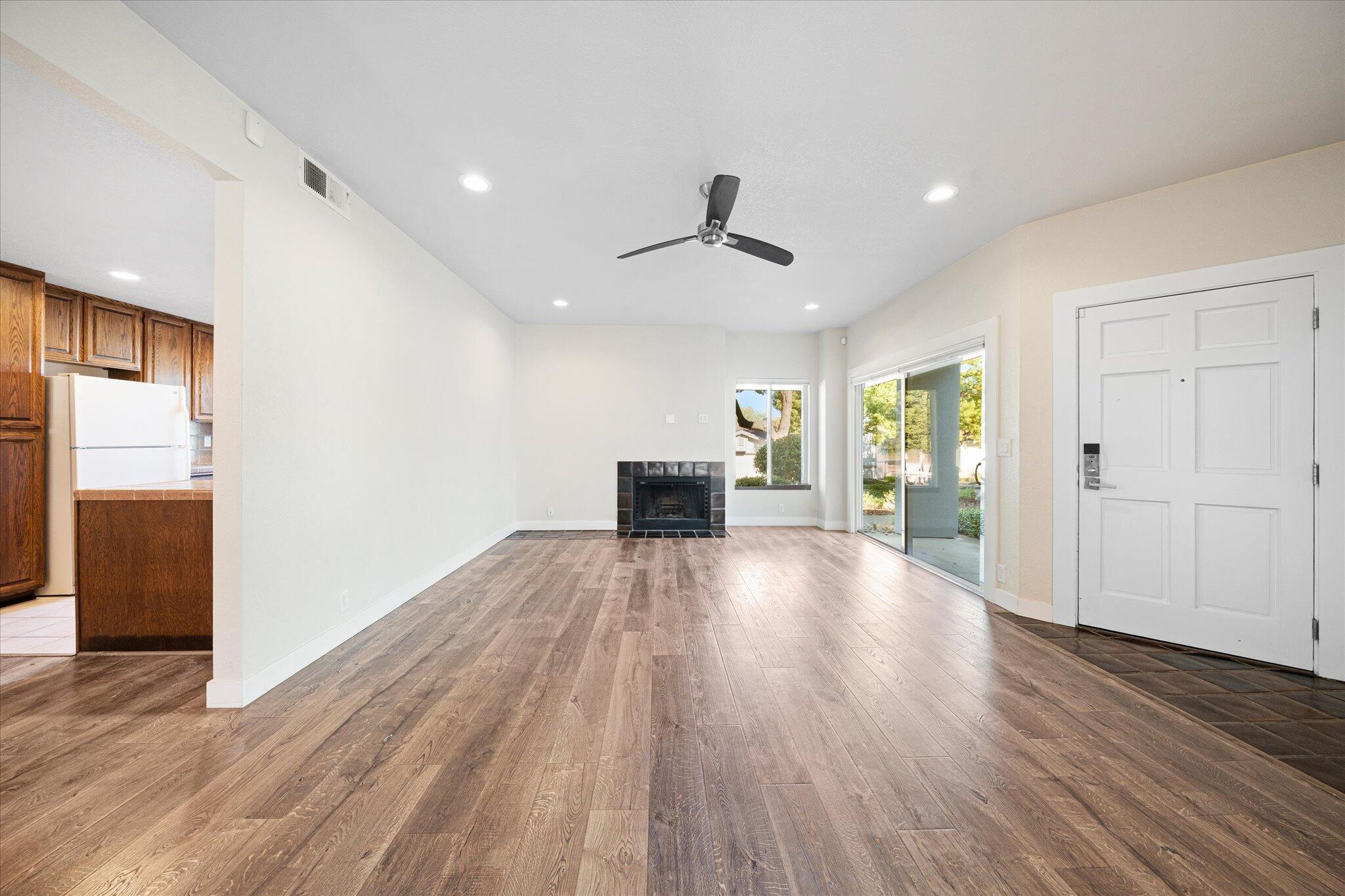 488 Ridgecrest Trail, Unit 132 Redding, CA 96003 - Photo 4 of 51 a view of empty room with wooden floor and fireplace