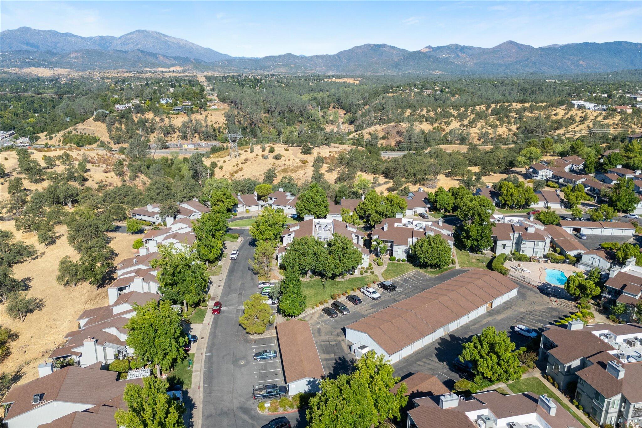 488 Ridgecrest Trail, Unit 132 Redding, CA 96003 - Photo 50 of 51 an aerial view of a city with lots of residential buildings and mountain view in back