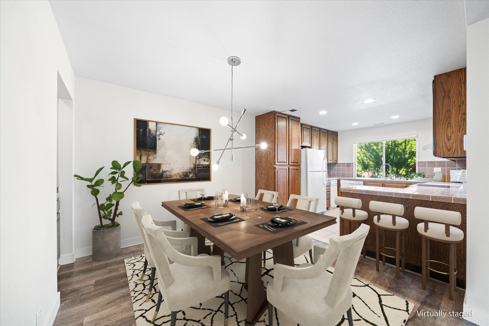 488 Ridgecrest Trail, Unit 132 Redding, CA 96003 - Photo 5 of 51 a dining room with furniture a chandelier and wooden floor