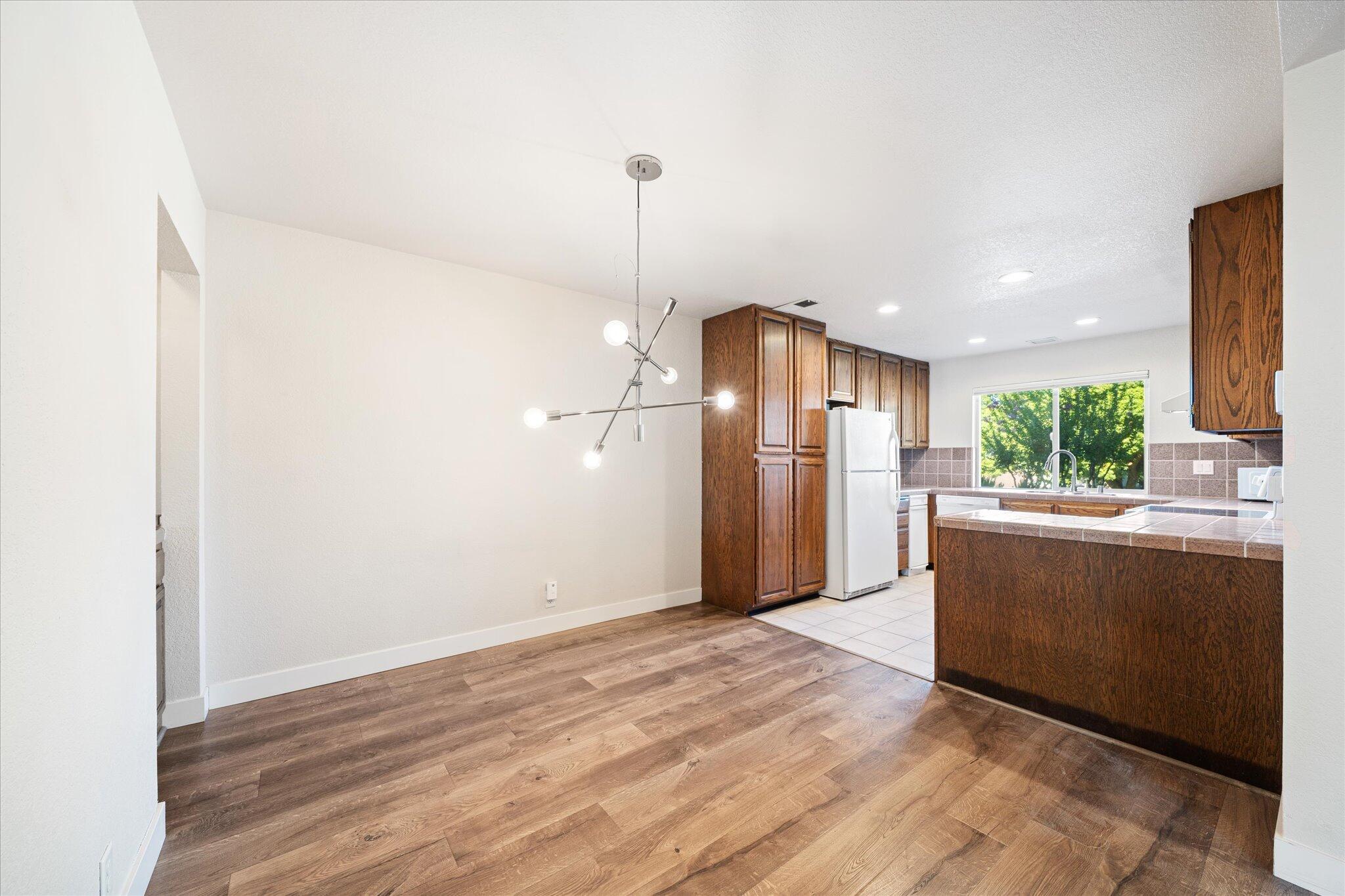 488 Ridgecrest Trail, Unit 132 Redding, CA 96003 - Photo 6 of 51 a view of a kitchen with a refrigerator and a floor to ceiling window