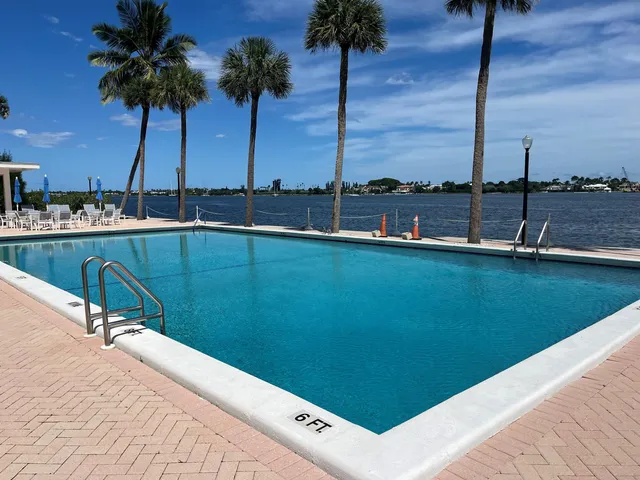 a terrace view with seating space and trees in the background