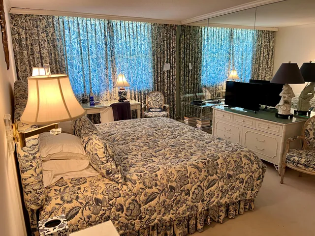 a bedroom with a bed and a potted plant