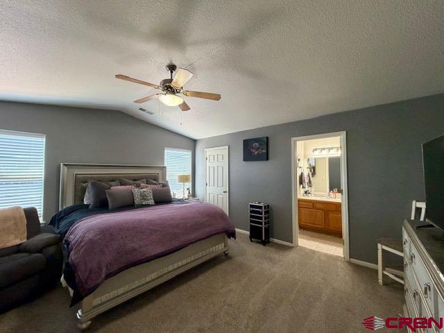 544 20th Street Delta, CO 81416 - Photo 20 of 44 a bedroom with a bed and a chandelier