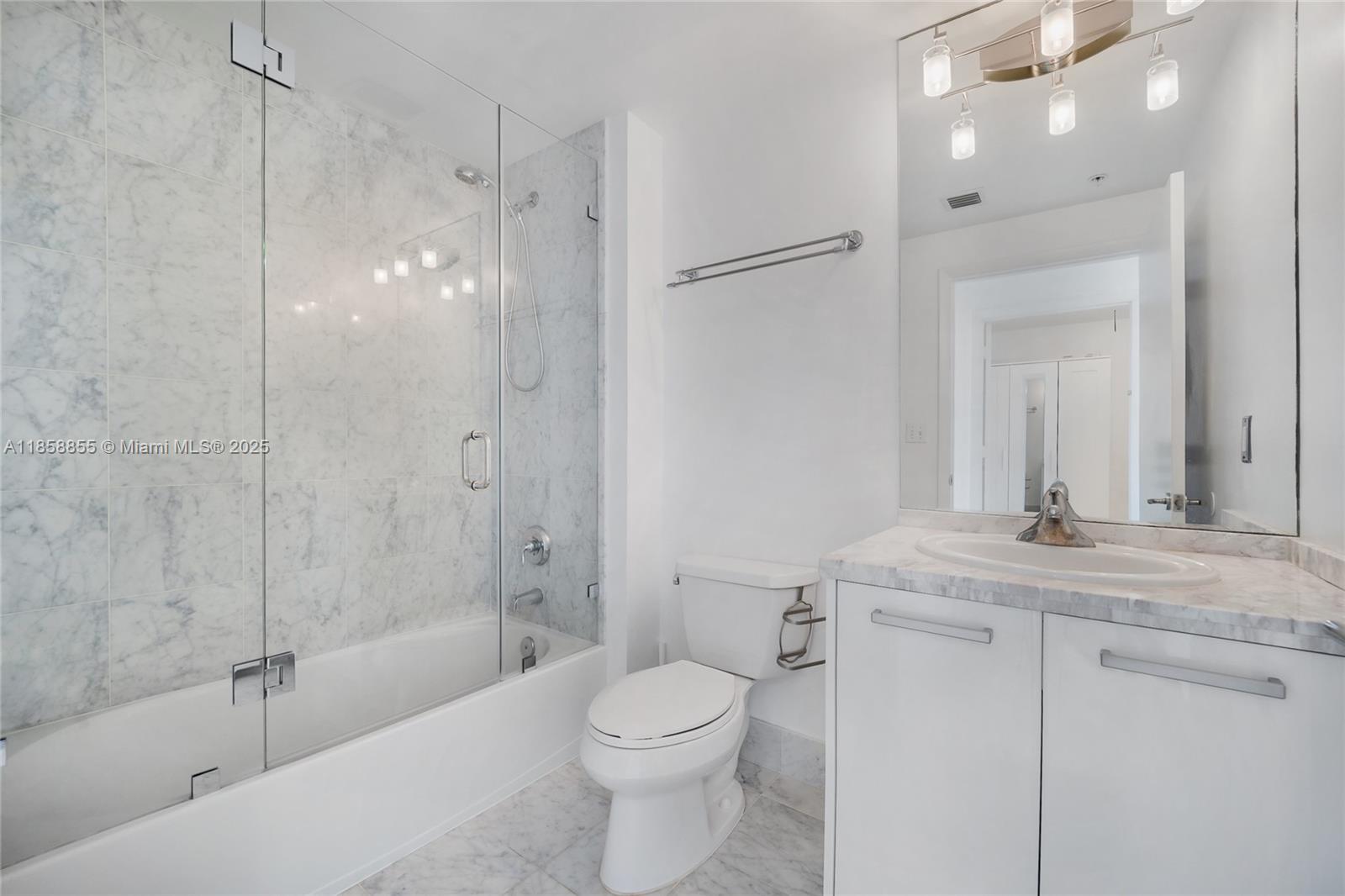 253 Northeast 2nd Street, Unit 3302 Miami, FL 33132 - Photo 14 of 27 a bathroom with a granite countertop sink a toilet and shower