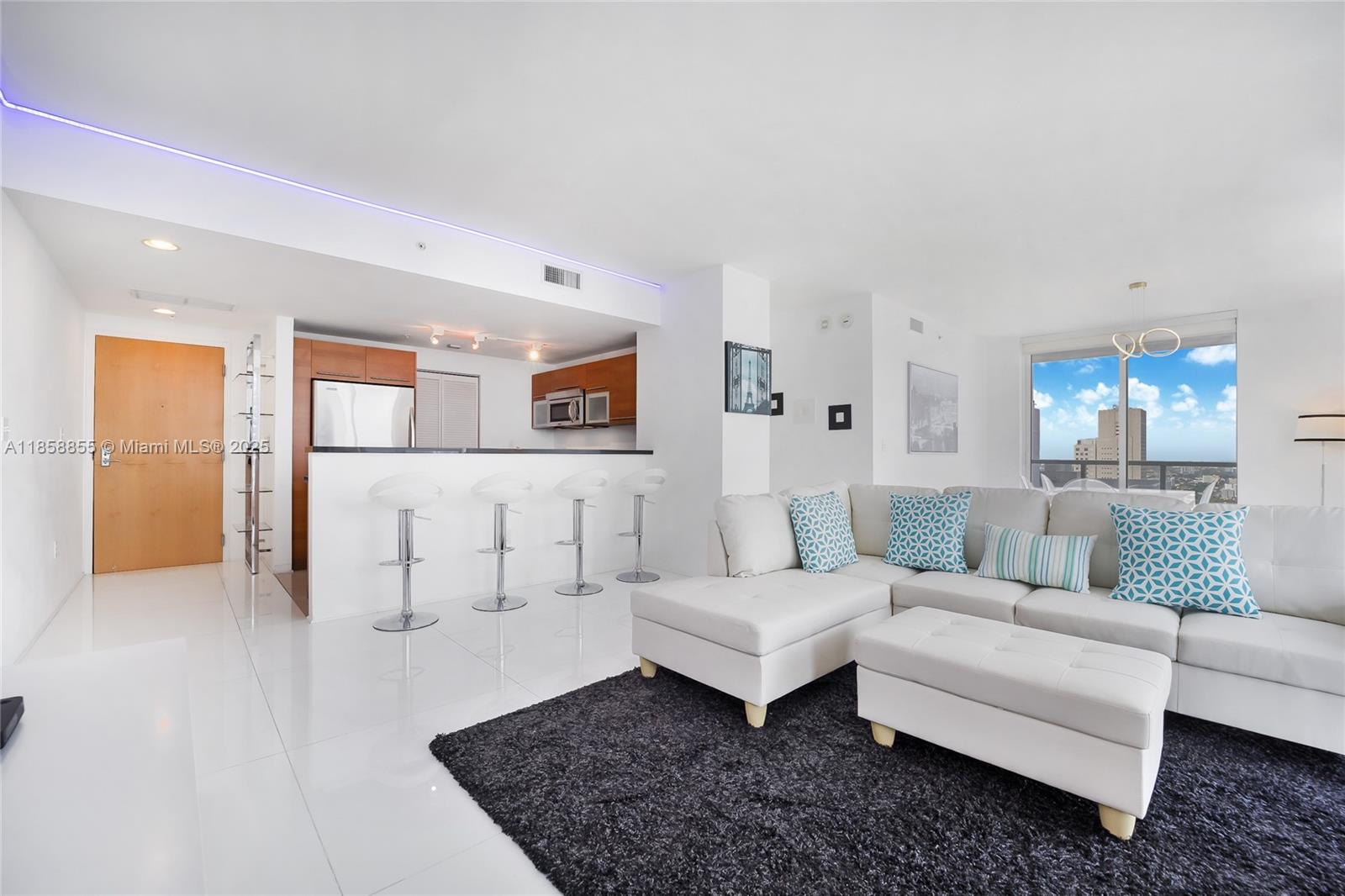 253 Northeast 2nd Street, Unit 3302 Miami, FL 33132 - Photo 2 of 27 a living room with furniture and a couch