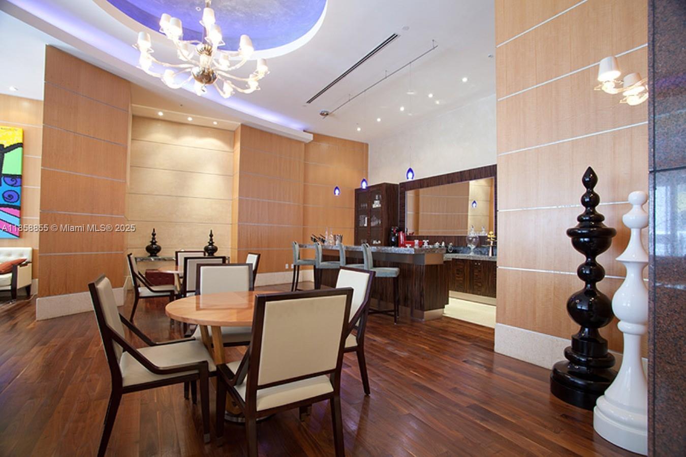 253 Northeast 2nd Street, Unit 3302 Miami, FL 33132 - Photo 23 of 27 a view of a dining room with furniture and wooden floor