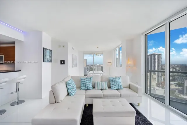 a living room with furniture and a large window