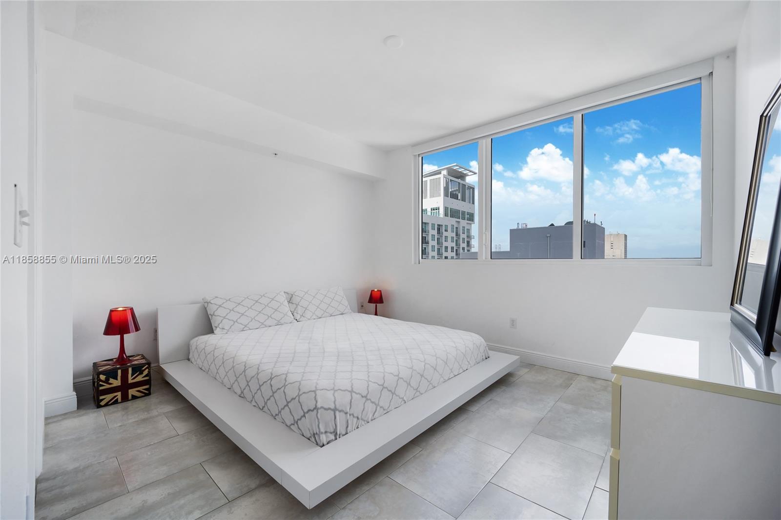 253 Northeast 2nd Street, Unit 3302 Miami, FL 33132 - Photo 9 of 27 a bedroom with a bed and a large window