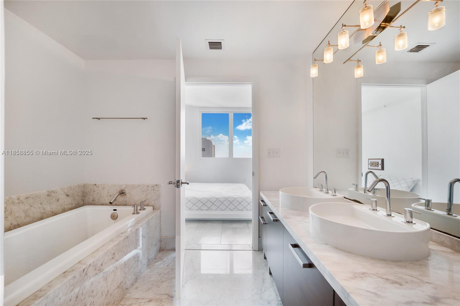 253 Northeast 2nd Street, Unit 3302 Miami, FL 33132 - Photo 10 of 27 a bathroom with a tub sink and mirror