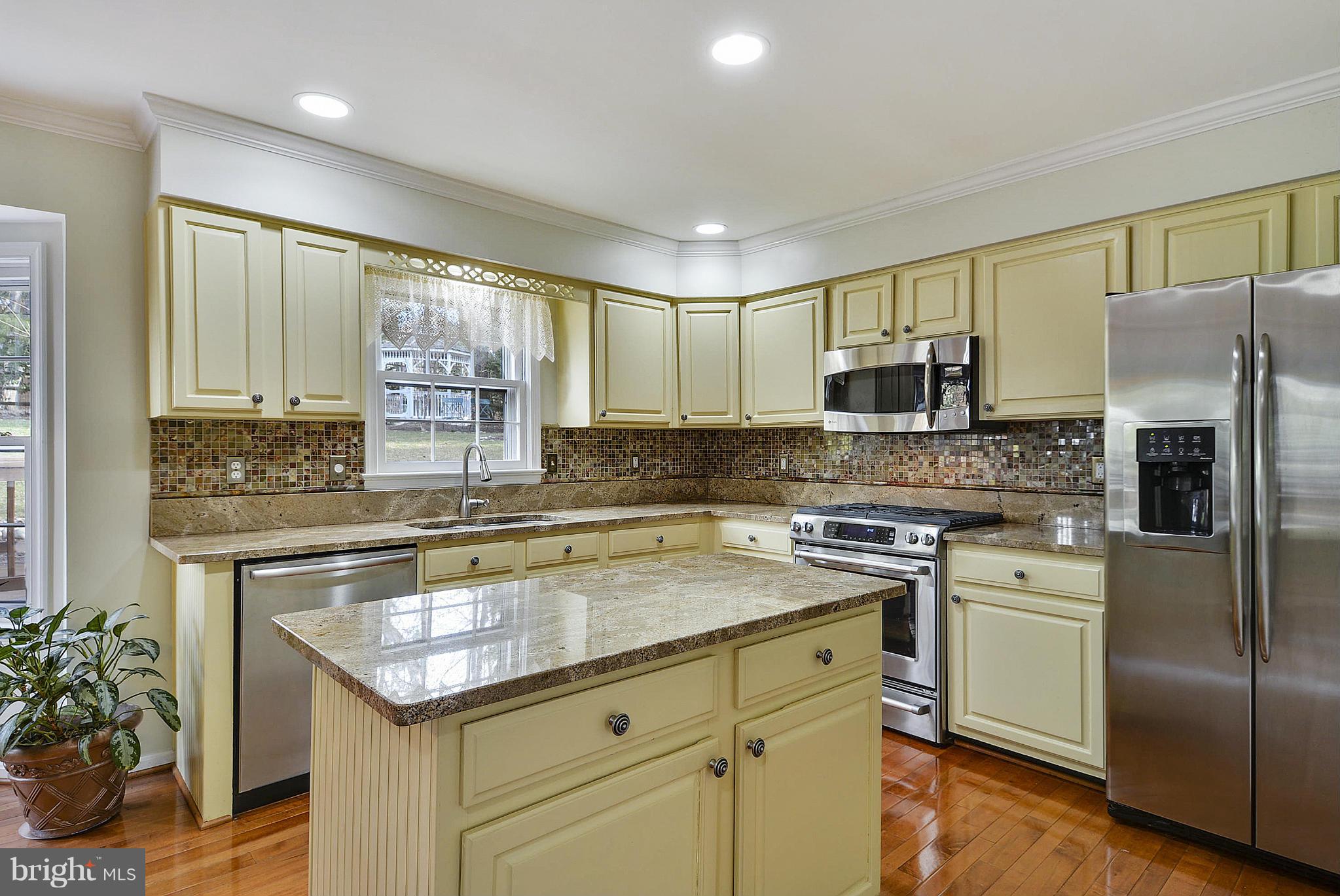 11952 Grey Squirrel Lane Reston, VA 20194 - Photo 5 of 30 a kitchen with a sink a center island stainless steel appliances and cabinets