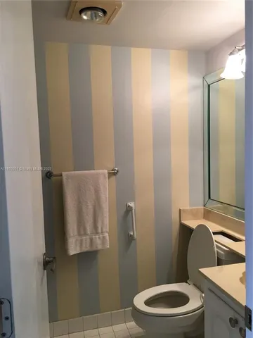 a bathroom with a toilet a sink and shower