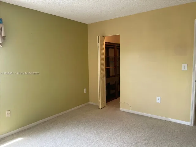 an empty room with a mirror