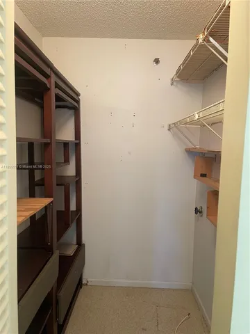 a view of a room with lounge chair and windows