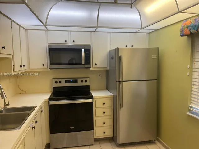 a kitchen with a refrigerator stove and microwave