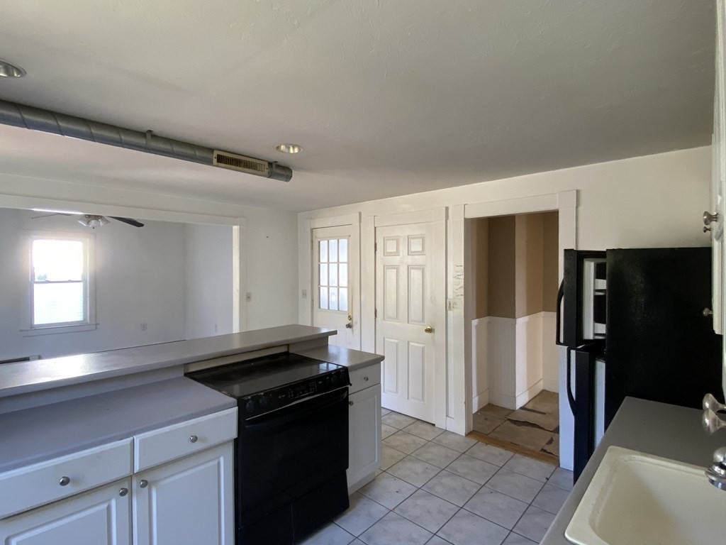 10 Thompson Road Webster, MA 01570 - Photo 17 of 37 a kitchen with a refrigerator and a sink