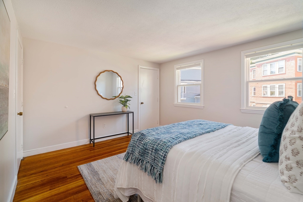 24 Goldsmith Street, Unit 24 Boston, MA 02130 - Photo 12 of 23 a bedroom with a bed window and a table