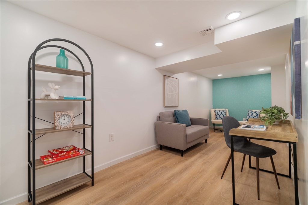 24 Goldsmith Street, Unit 24 Boston, MA 02130 - Photo 15 of 23 a living room with furniture a rug and a potted plant