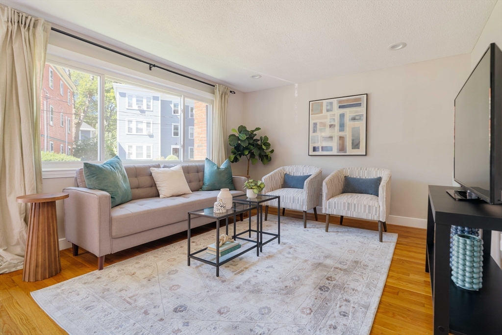 24 Goldsmith Street, Unit 24 Boston, MA 02130 - Photo 2 of 23 a living room with furniture and a flat screen tv