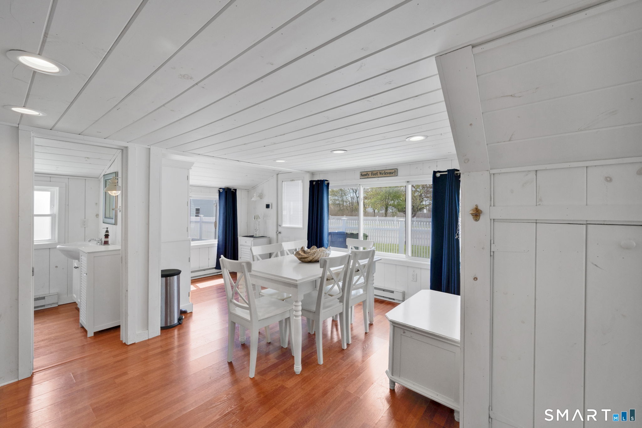 96 Chalker Beach Road Old Saybrook, CT 06475 - Photo 19 of 33 a view of a dining room with furniture window and wooden floor