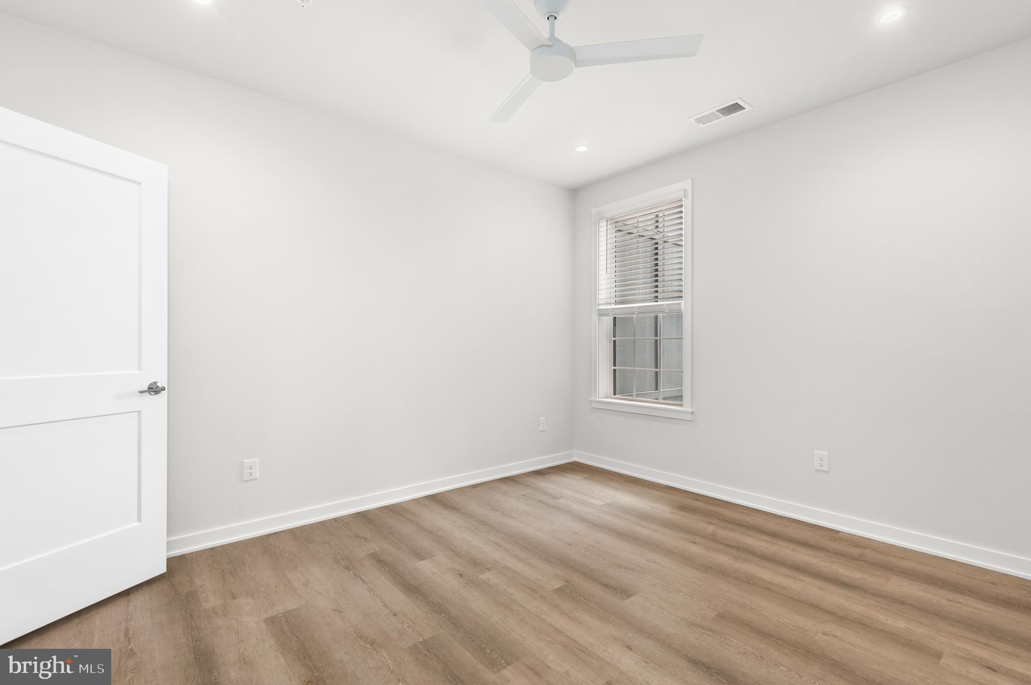 26 South York Road, Unit 301 Hatboro, PA 19040 - Photo 12 of 52 an empty room with wooden floor and windows