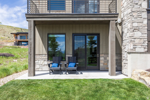 140 West Vista Road Kamas, UT 84036 - Photo 70 of 101 Ground-level patio with sliding glass door access, featuring a stone and wood-paneled exterior