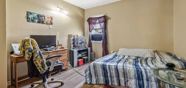 a bedroom with a bed and a desk