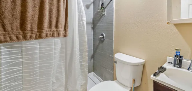 a white toilet sitting next to a bathroom sink