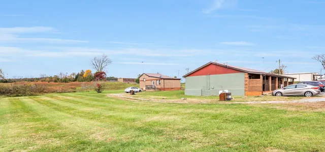 a view of a houses with yard and slide
