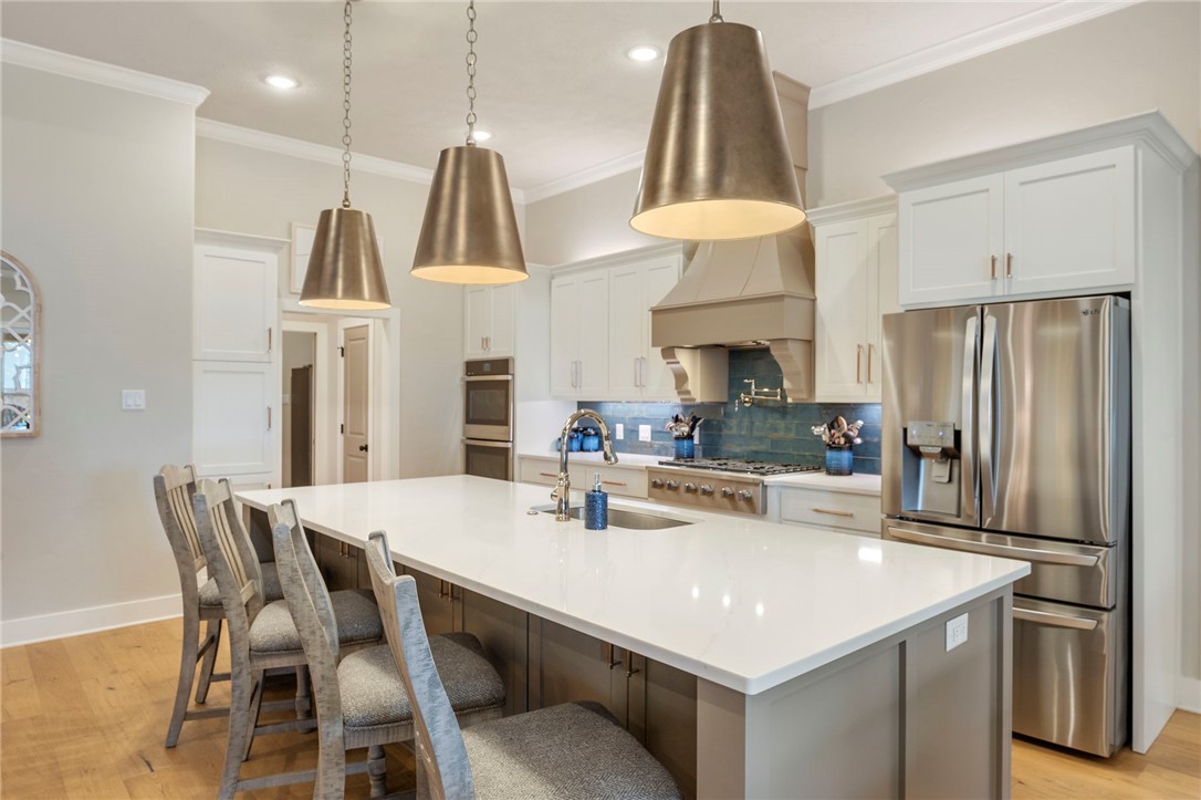 4804 Crystal Ridge Court College Station, TX 77845 - Photo 14 of 48 a kitchen with stainless steel appliances a dining table chairs and a refrigerator