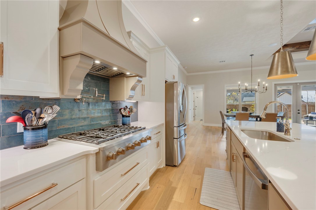 4804 Crystal Ridge Court College Station, TX 77845 - Photo 18 of 48 a kitchen with stainless steel appliances a sink a stove and a refrigerator