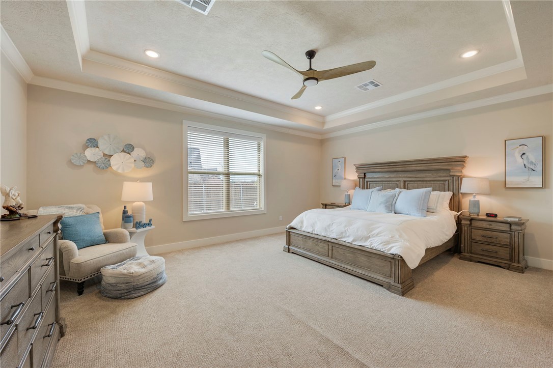 4804 Crystal Ridge Court College Station, TX 77845 - Photo 19 of 48 a spacious bedroom with a bed and a chandelier