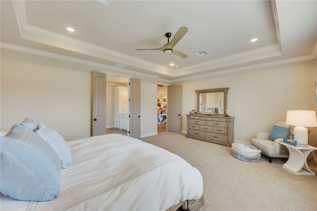 4804 Crystal Ridge Court College Station, TX 77845 - Photo 20 of 48 a spacious bedroom with a bed and a chandelier