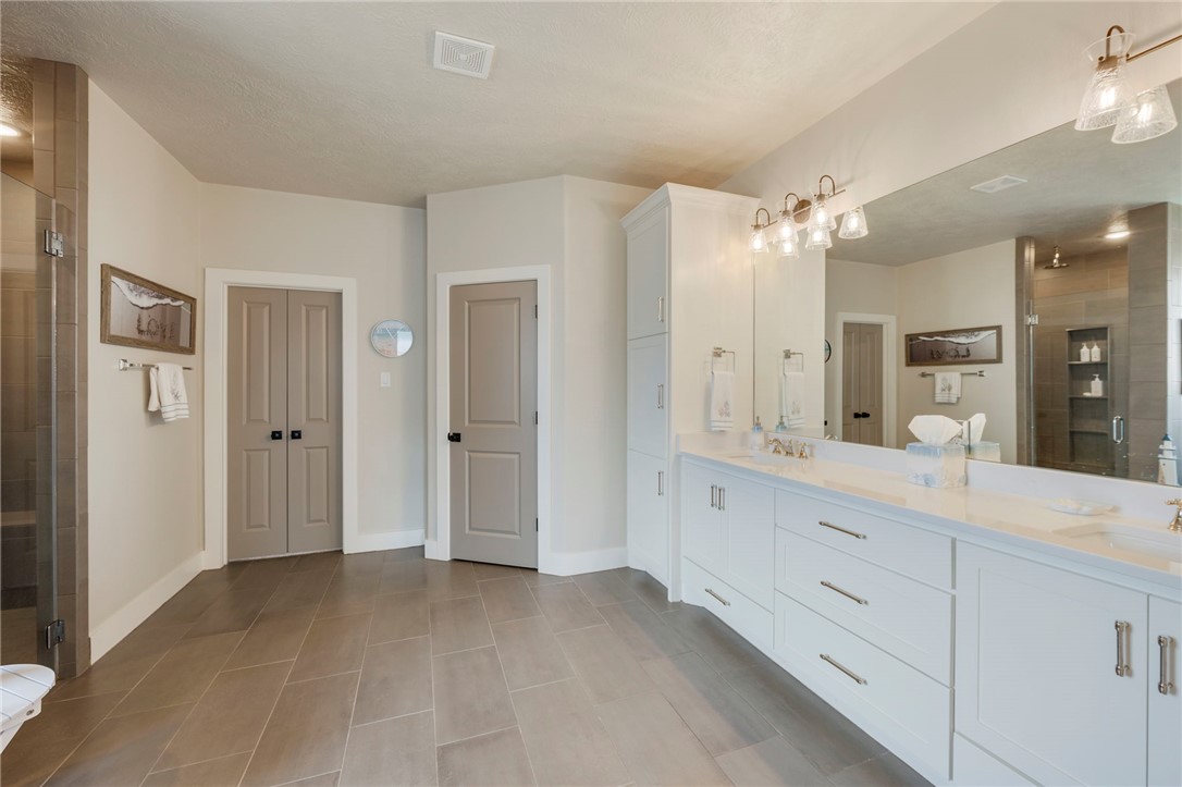 4804 Crystal Ridge Court College Station, TX 77845 - Photo 21 of 48 a spacious bathroom with a granite countertop sink mirror and shower