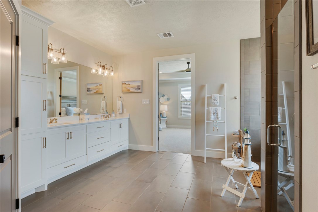 4804 Crystal Ridge Court College Station, TX 77845 - Photo 23 of 48 a spacious bathroom with a double vanity sink toilet mirror and shower
